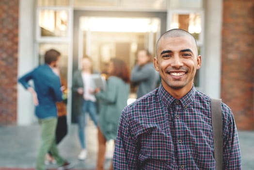 Time to get this semester started. Portrait of a happy young man standing outdoors on campus