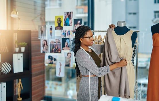 Dont tell people your dreams, show them. a young woman working in her clothing boutique