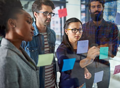 Putting things into perspective for her team. coworkers brainstorming in a modern office