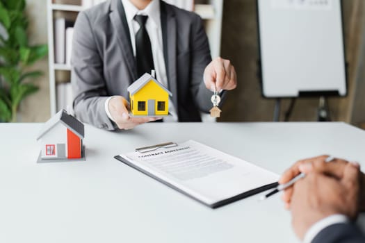 Real estate company to buy houses and land are delivering keys and houses to customers after agreeing to make a home purchase agreement and make a loan agreement