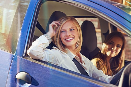 Driving around town. two young women traveling in a car in the city