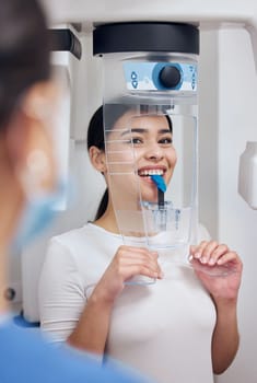 This always feels so awkward. a young woman getting her teeth scanned for a mold at the dentists office