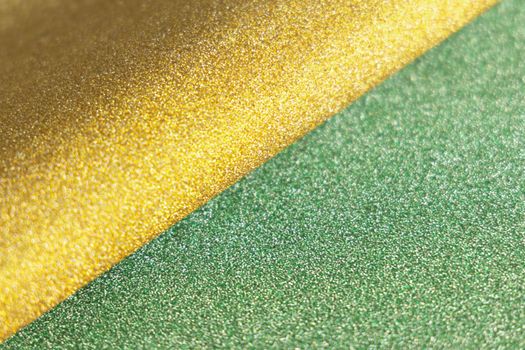 Golden and green wave shiny glitter paper texture. Shining luxurious fabric. Glimmering light green golden color, christmas background