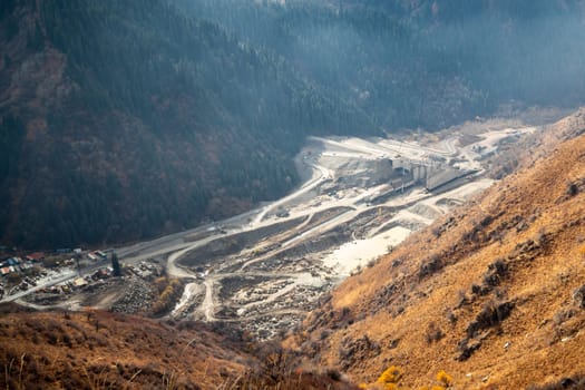 View from the mountain on construction of a mudflow protection dam in the Big Almaty Gorge in the mountains of Almaty. Almaty, Kazakhstan - September 28, 2022