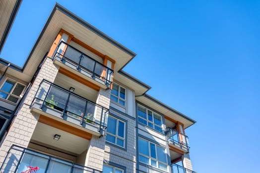 Corners of new residential building on blue sky background.