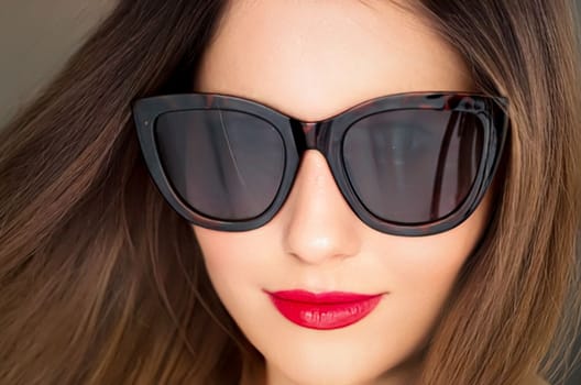 Beauty, fashion and style, face portrait of beautiful woman wearing stylish cat eye sunglasses and red lipstick make-up, luxury accessory and summer lifestyle, glamour and chic look.