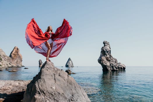 Woman travel sea. Happy tourist taking picture outdoors for memories. Woman traveler looks at the edge of the cliff on the sea bay of mountains, sharing travel adventure journey.