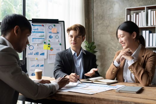 Business People Meeting using laptop computer, calculator, stock market chart paper for analysis planning to improve quality next month. Conference Discussion Corporate Concept.