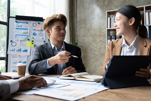 Business People Meeting using laptop computer, calculator, stock market chart paper for analysis planning to improve quality next month. Conference Discussion Corporate Concept.