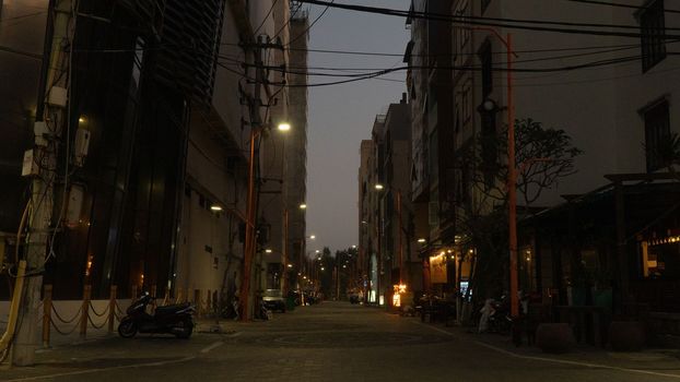 Asian street in the evening with street lamps and tangled electric wires. High quality photo