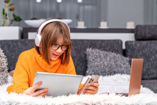 children and modern technology. play and study at home using a laptop, tablet, smartphone and wireless headphones. generation Z