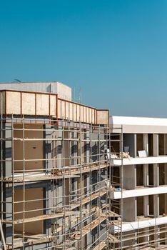 Construction scaffolding built on a new apartment building. new construction under construction