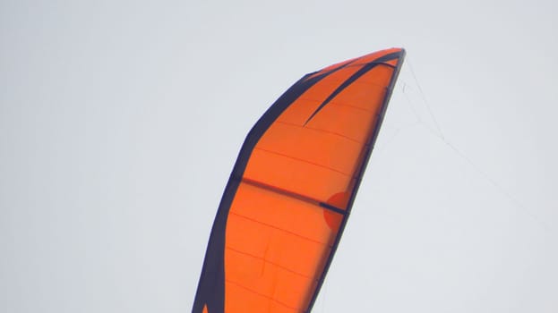 orange sport kite in the sky, parachute.