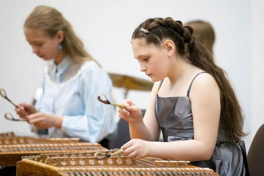 May 21, 2021 Belarus. city of Gomil. Holiday at the music school.The girl plays the ethnic instrument dulcimer