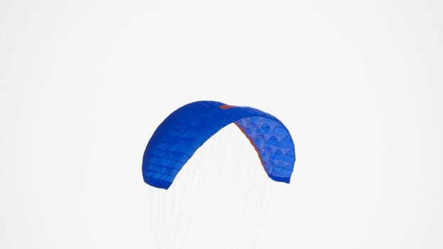 blue sport kite in the sky, parachute.