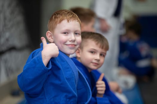 Belarus, city of Gomil, December 15, 2021. Judo school for children. Children judoists show the class sign with their fingers.