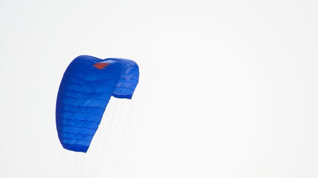 blue sport kite in the sky, parachute.