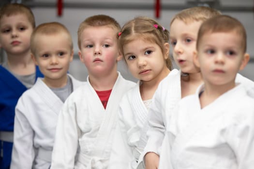 Belarus, city of Gomil, December 15, 2021. Judo school for children. A group of small children in kimanos lined up before training.