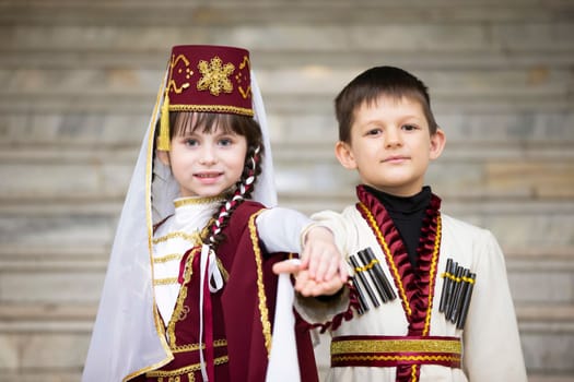 Belarus, city of Gomel, May 21, 2021 Children's holiday in the city. A boy and a girl in national Georgian clothes.