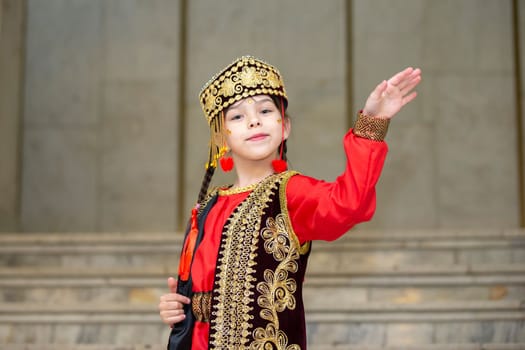 Belarus, city of Gomel, May 21, 2021 Children's holiday in the city. A little girl in Uzbek national costume is dancing.