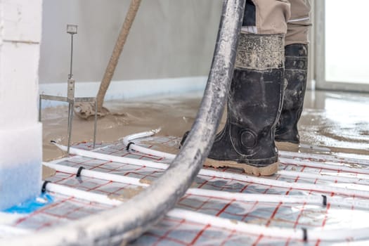 covering the floor heating with anhydride and concrete. High quality photo
