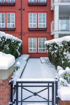 Pathway to residential building covered with snow. Residence on the winter season.