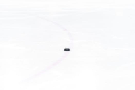 hockey puck on the ice of the winter stadium. High quality photo