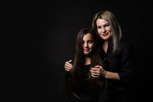 portrait of young woman with her little girl.
