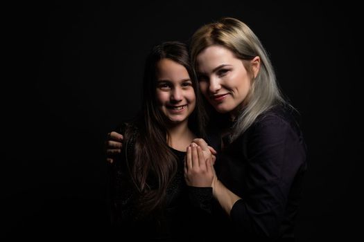 Little girl hugs her mother