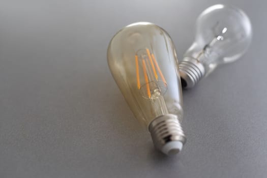 Power energy saving concept. light bulb with light on on gray background