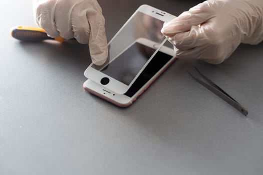 a person places a protective glass or film on a smartphone. copy space