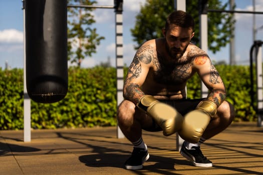 boxer athlete man putting on glove gloves prepared to train outdoors