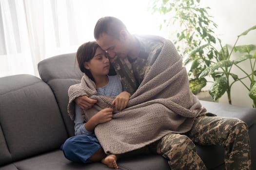 pretty little girl hugging her military father