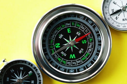 Navigation concept. Compass set on nice yellow background