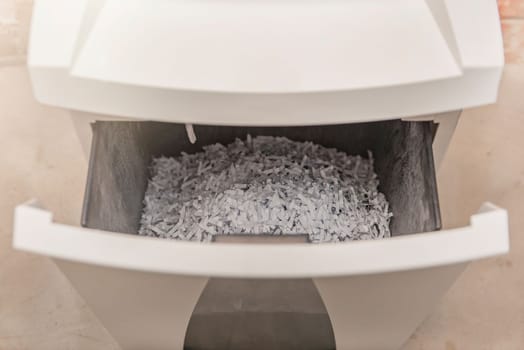 Industrial paper shredder. Paper shredder in the office, use and maintenance of professional office equipment