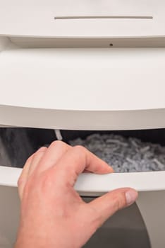 Industrial paper shredder. Paper shredder in the office, use and maintenance of professional office equipment