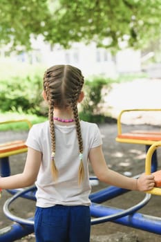 Girl with pigtails playing at the playground