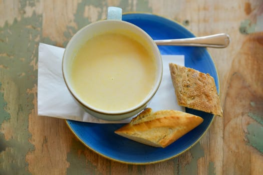 White asparagus soup on a shabby table in a restaurant