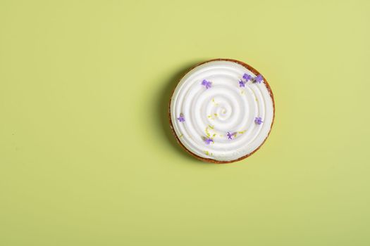 One mousse cake decorated with lavender flowers on green surface, High quality photo