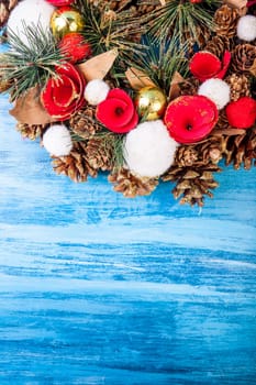 Christmas wreath on blue wooden background in studio photo