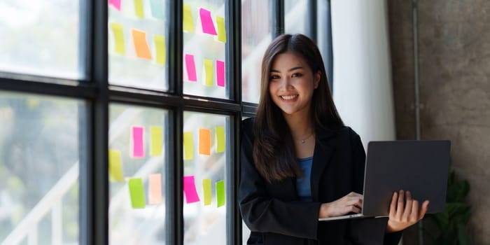 Portrait of Business woman analytic finance statistics and planning strategy by laptop. tax, report, accounting concept.