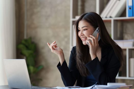 Beautiful business woman talking on the mobile phone. Management, planning and networking phone call concept.