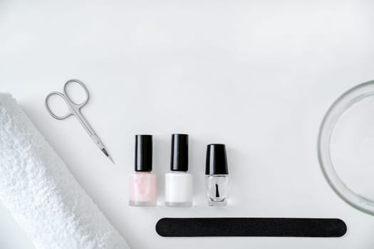 Set of accessories for manicure and hand care on white background, flat lay, top view, copy space