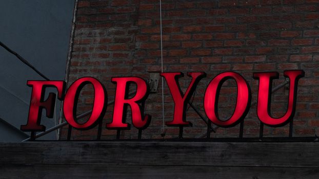 Red lettering for you sign against a brick wall loft style. High quality photo