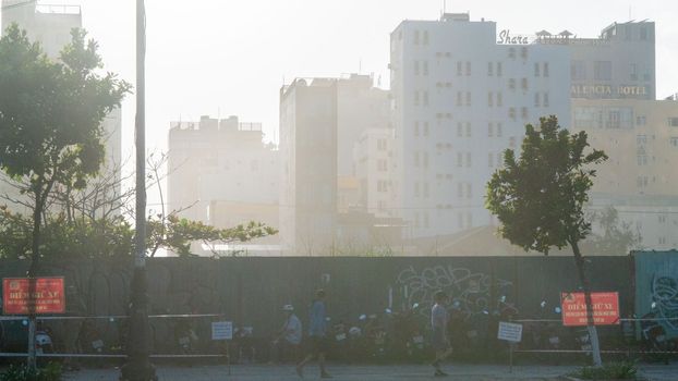 Early foggy morning on a city street with graffiti fence. High quality photo