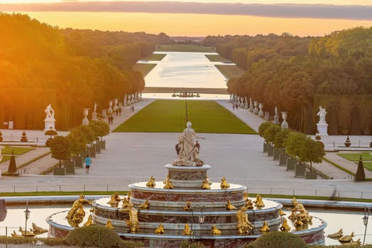 Garden of Chateau de Versailles and the Latona Fountain, near Paris in France at sunset