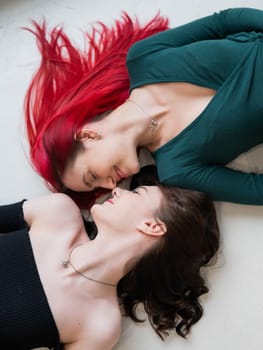 Top view of caucasian women lying and kissing