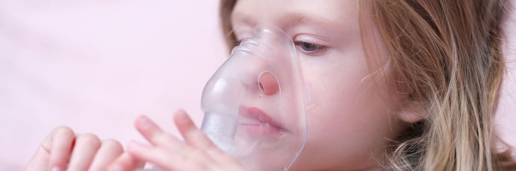 Portrait of child girl with inhaler for asthma. Oxygen mask for children concept