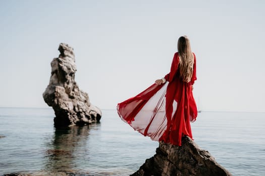 Woman travel sea. Happy tourist taking picture outdoors for memories. Woman traveler looks at the edge of the cliff on the sea bay of mountains, sharing travel adventure journey.