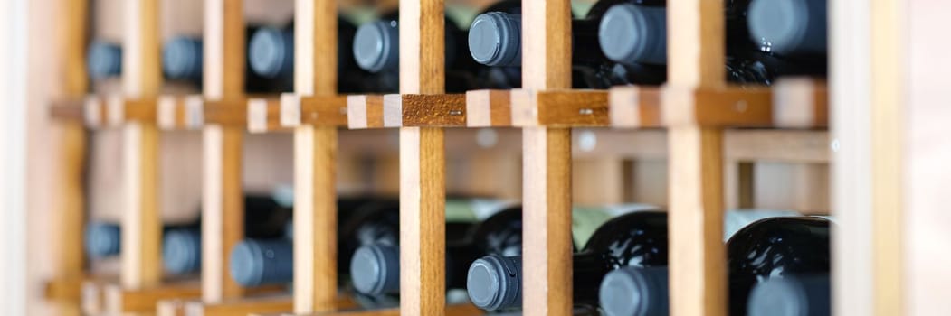 Homemade wine cellar with wooden boxes for storing bottles. Storage of elite wine concept